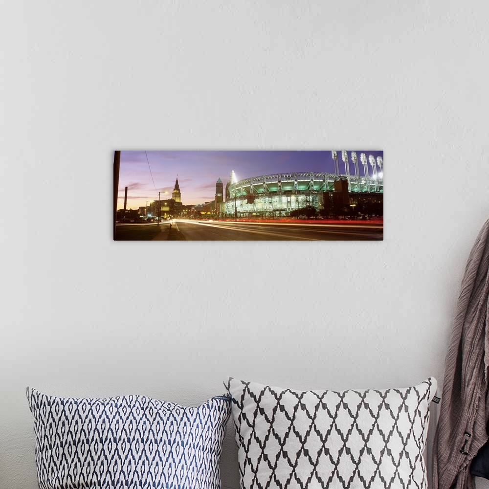 A bohemian room featuring Panoramic photograph of sports arena light up at night with city skyline in the distance.