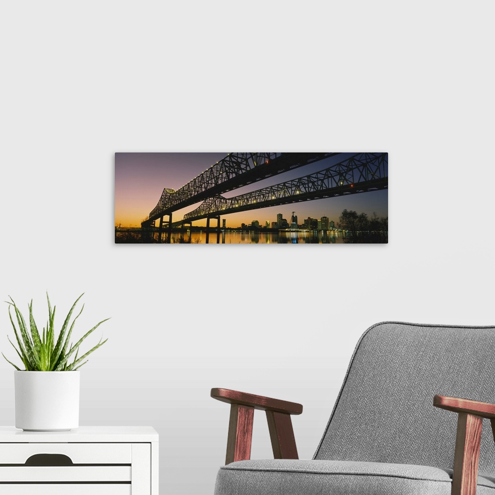 A modern room featuring Large panoramic photograph taken beneath a long bridge running across a river in New Orleans, Lou...