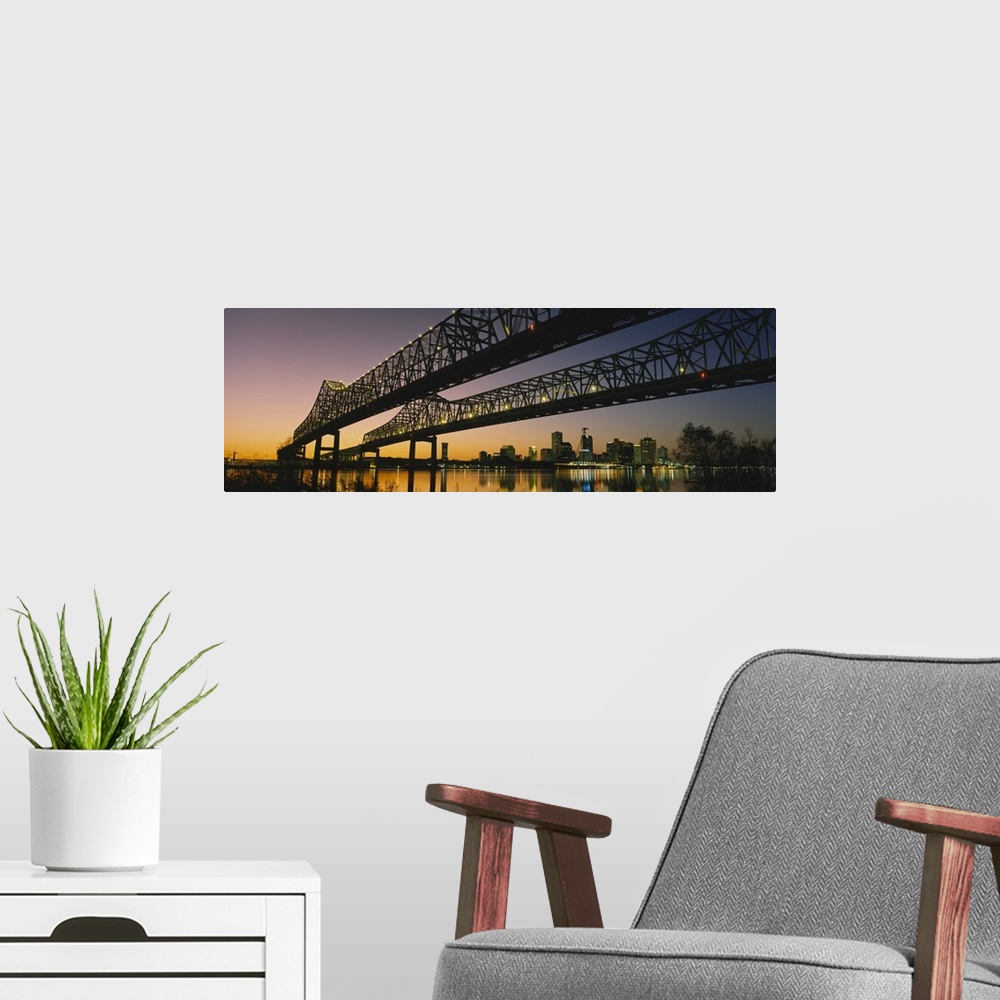 A modern room featuring Large panoramic photograph taken beneath a long bridge running across a river in New Orleans, Lou...