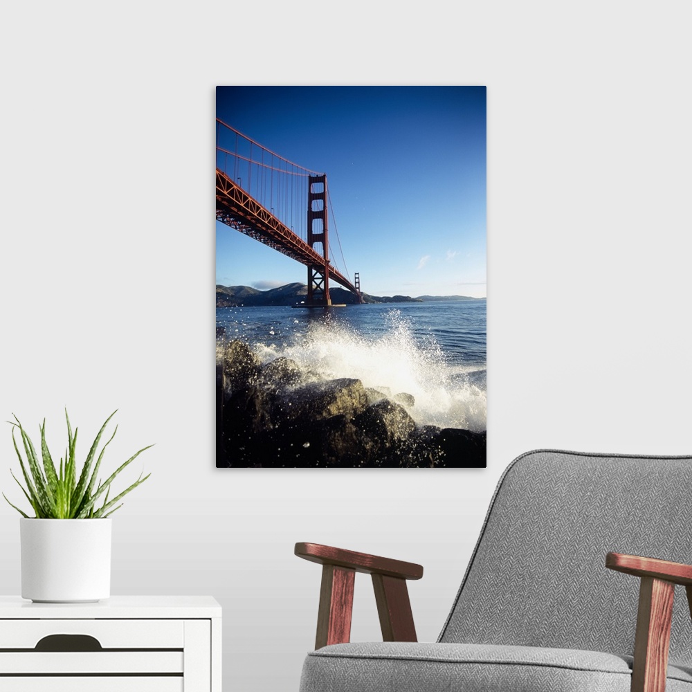 A modern room featuring Huge photograph displays a rocky shoreline being beaten with water from the surrounding bay in th...