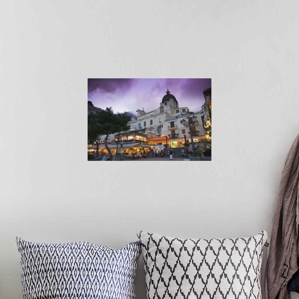 A bohemian room featuring A large church is photographed from street view and illuminated under a purple sky.