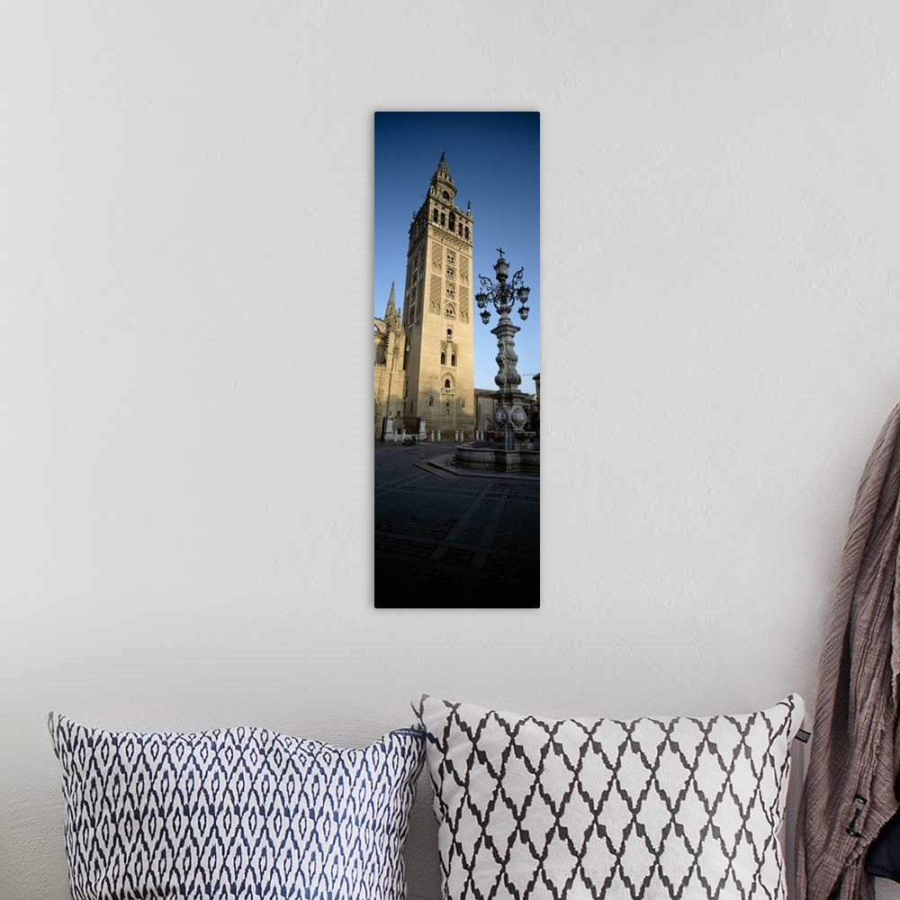 A bohemian room featuring Low angle view of a lamppost in front a church, La Giralda, Seville Cathedral, Seville, Seville P...