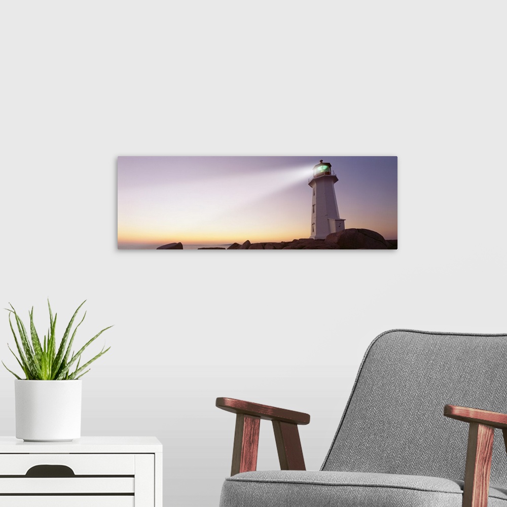 A modern room featuring This panoramic piece is a picture taken of a lighthouse that sits on a rocky cove and shines out ...