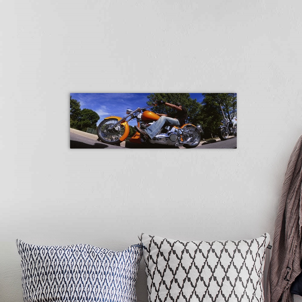 A bohemian room featuring Low angle view of a man riding a motorcycle, Wisconsin