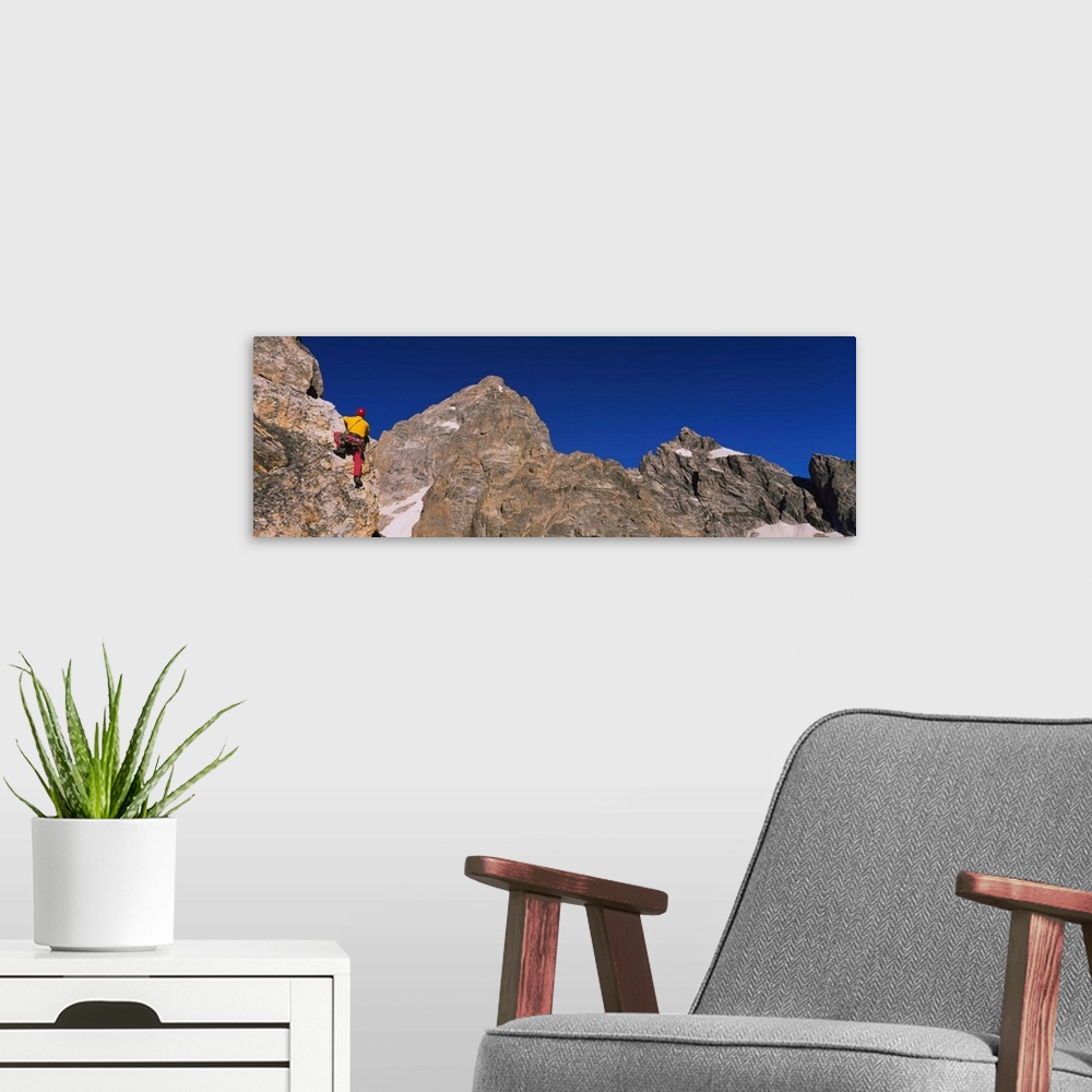A modern room featuring Low angle view of a person rock climbing, Grand Teton National Park, Wyoming