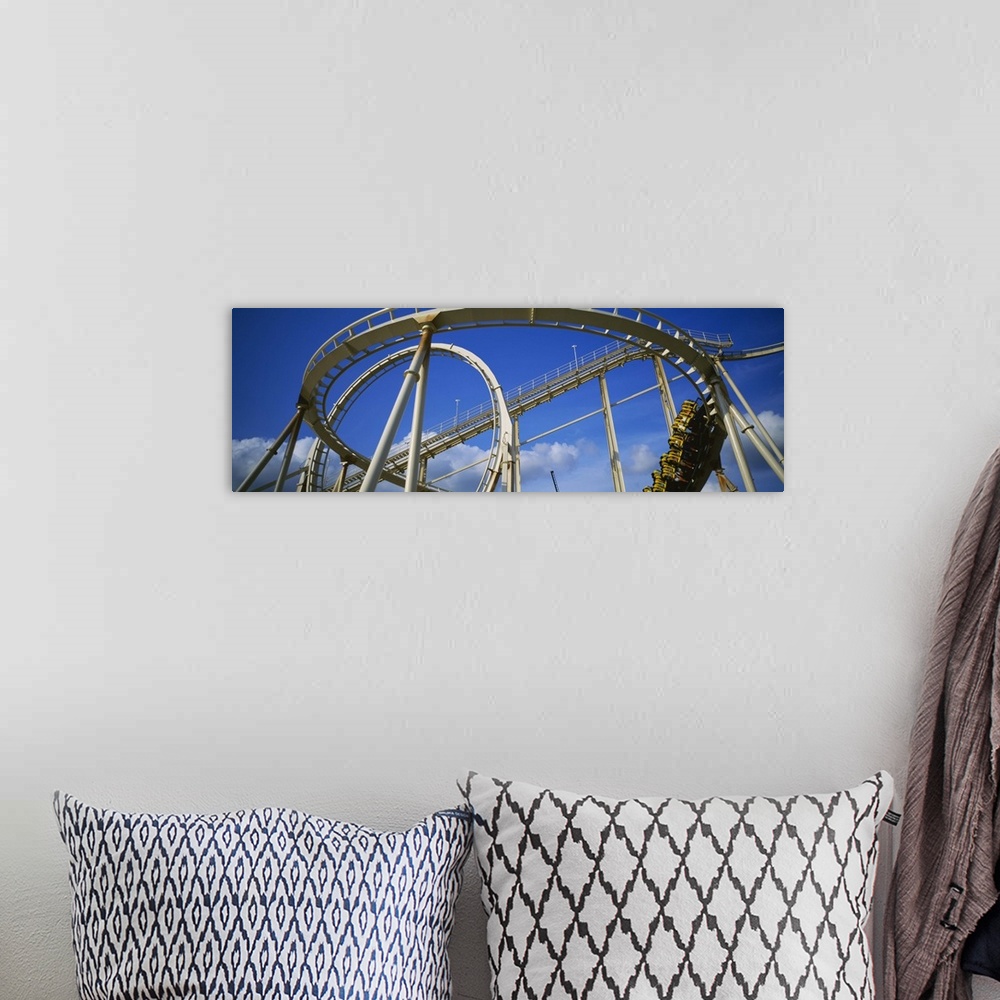 A bohemian room featuring Low angle view of a rollercoaster in an amusement park