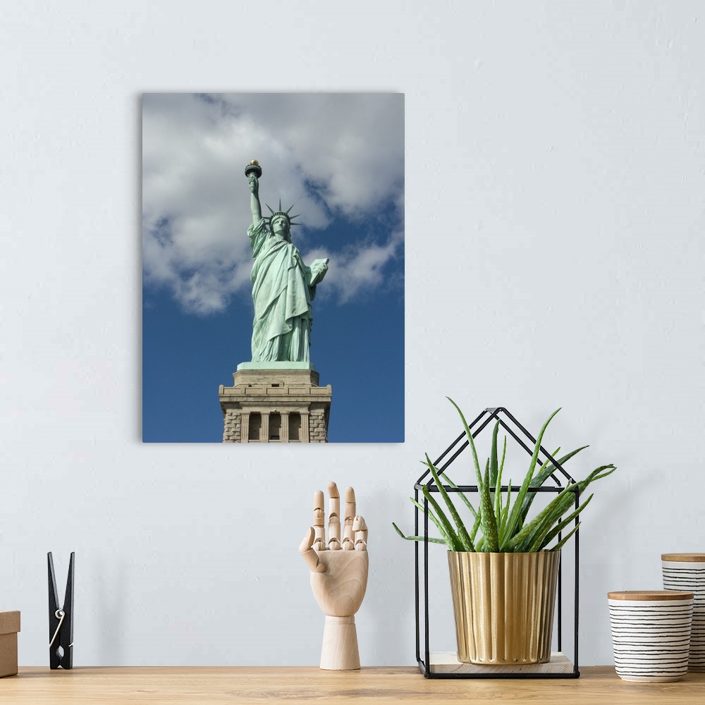A bohemian room featuring Vertical, low angle photograph on a big canvas, looking up at the Statue of Liberty against a blu...