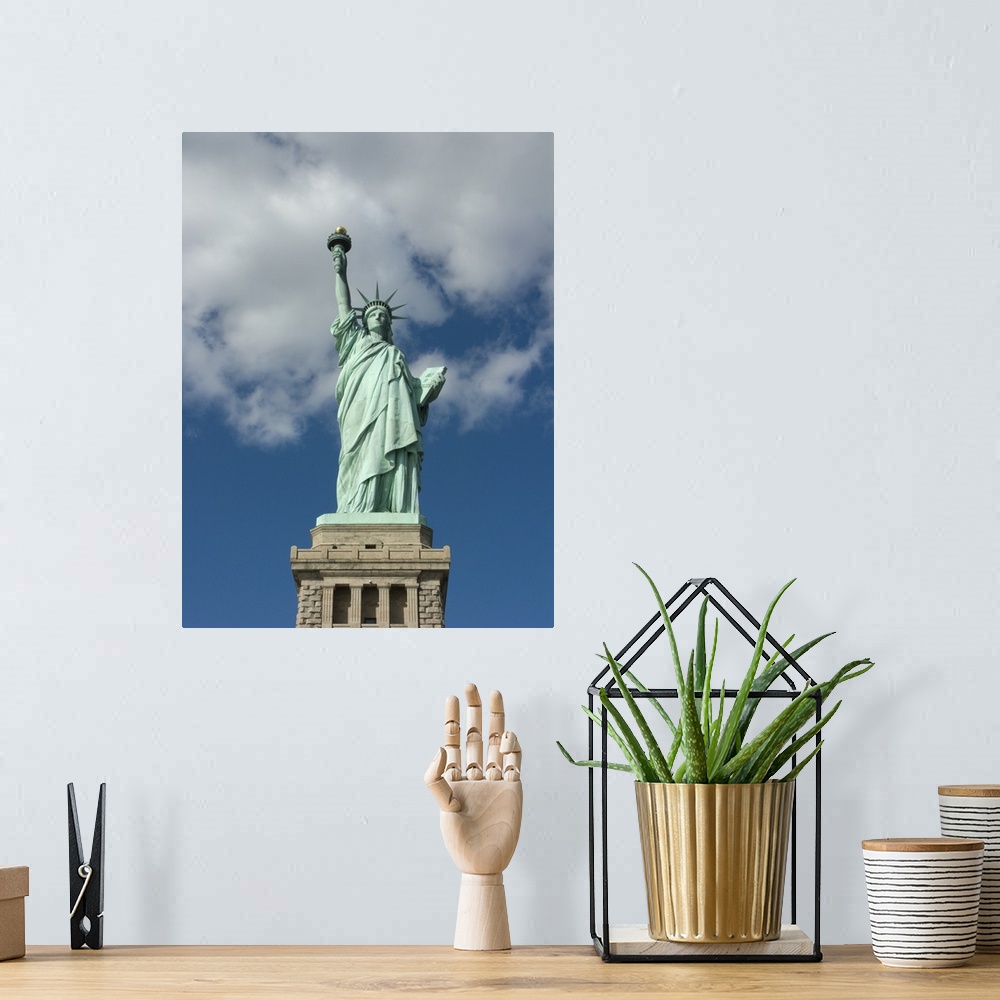 A bohemian room featuring Vertical, low angle photograph on a big canvas, looking up at the Statue of Liberty against a blu...