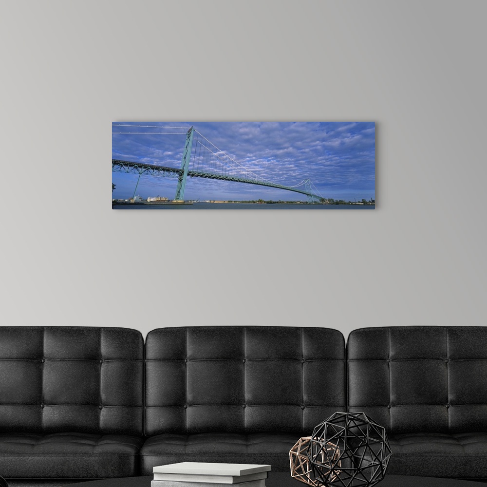 A modern room featuring Long and horizontal image print of a long bridge spanning across the river in Detroit.