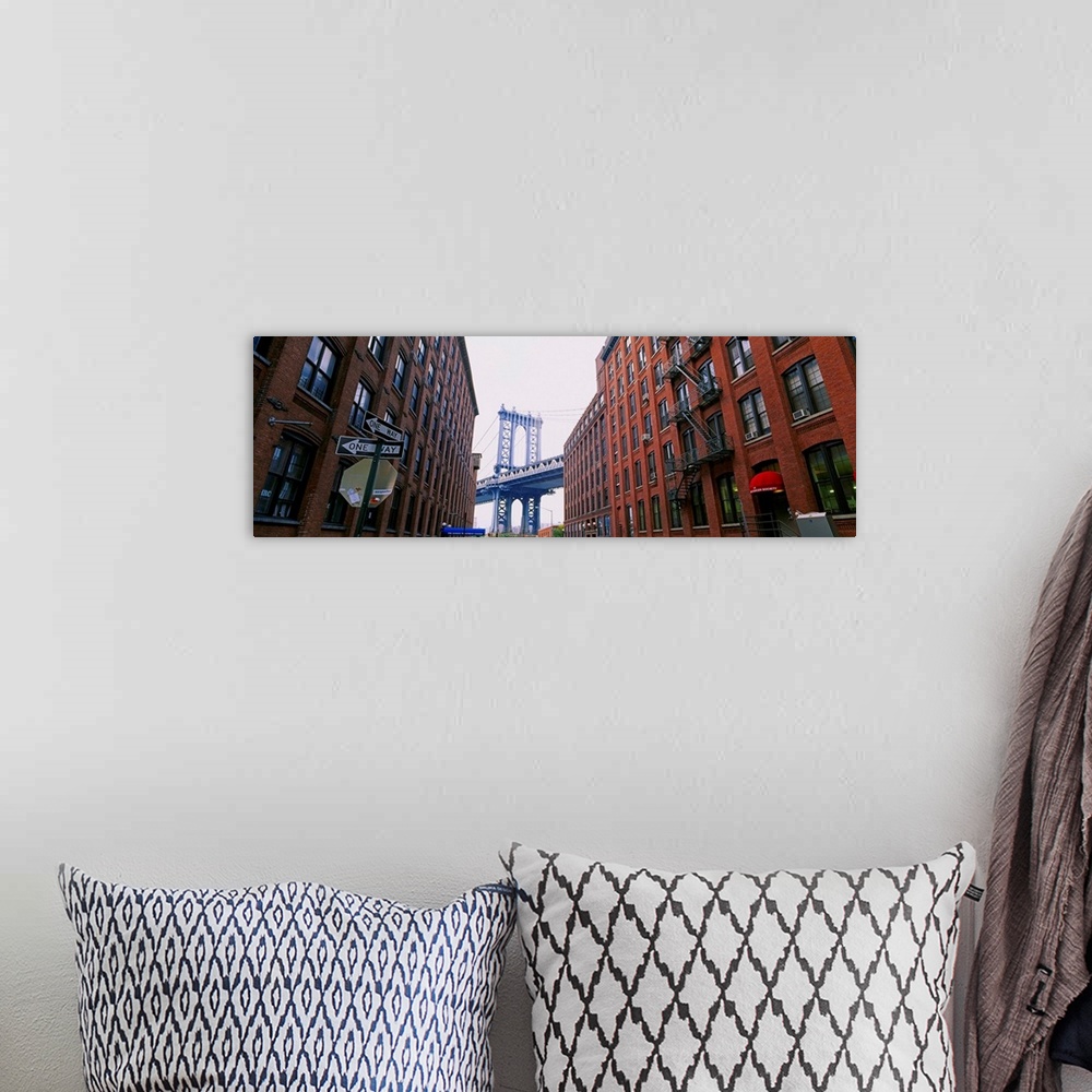 A bohemian room featuring Low angle view of a suspension bridge viewed through buildings, Manhattan Bridge, Brooklyn, New Y...
