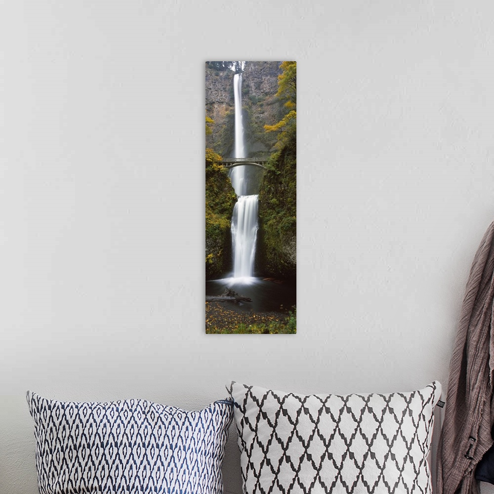 A bohemian room featuring Vertical panoramic photograph of two large waterfalls, one feeding in to the other, and an arched...
