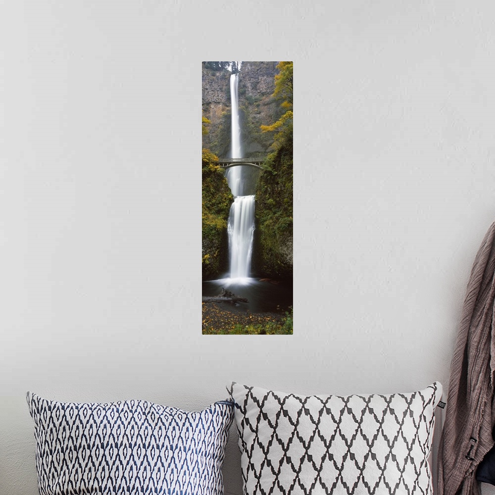 A bohemian room featuring Vertical panoramic photograph of two large waterfalls, one feeding in to the other, and an arched...