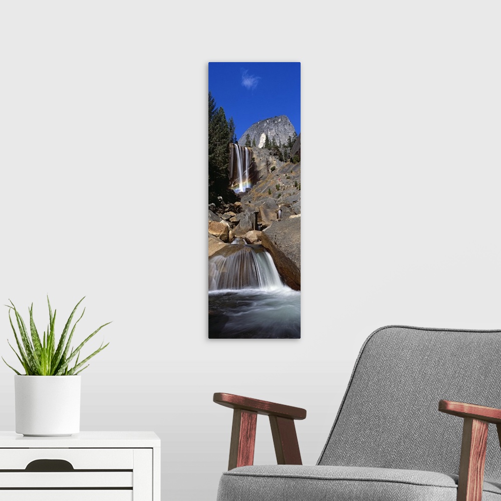 A modern room featuring This picture is taken from below and looking up toward the top of a waterfall that flows over lar...