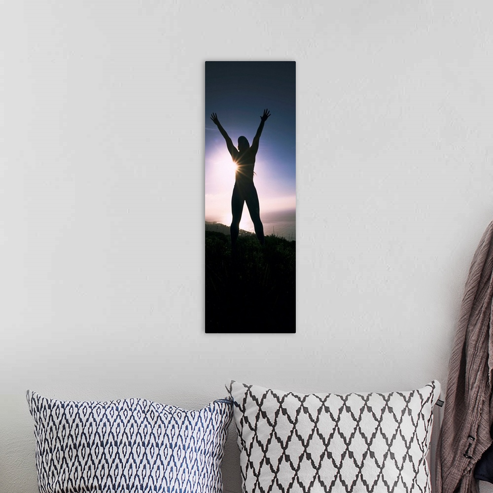 A bohemian room featuring Low angle view of a young woman exercising on a hill