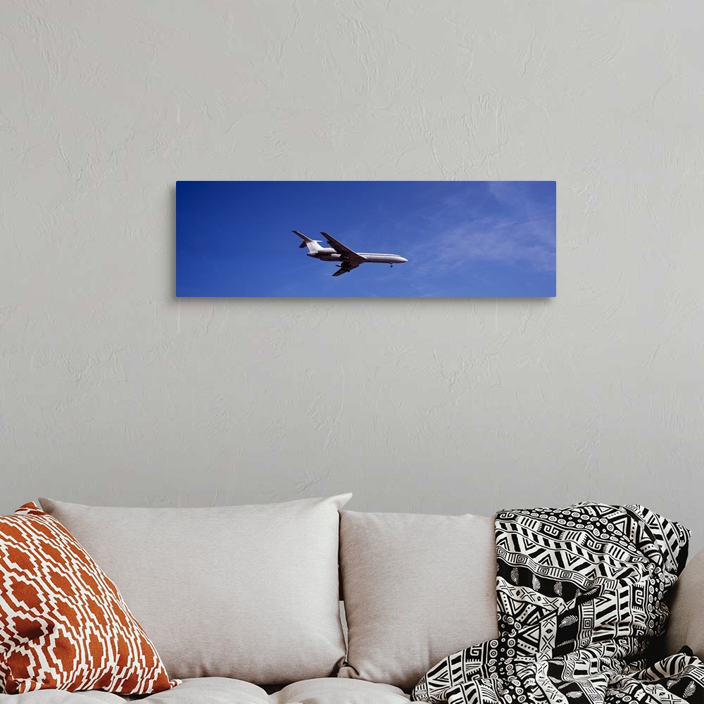 A bohemian room featuring Low angle view of an airplane flying, Tupolev Tu-154