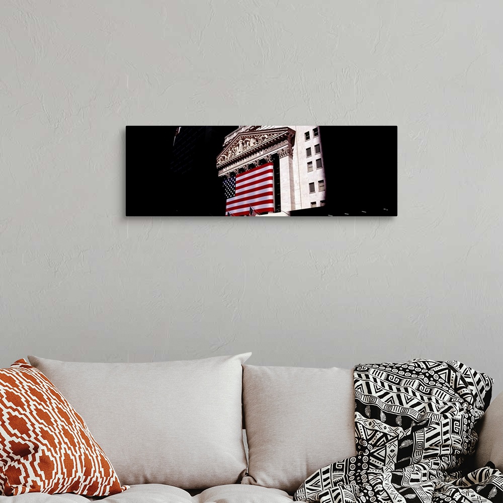 A bohemian room featuring Low angle view of an American flag on a financial building, New York Stock Exchange, Wall Street,...