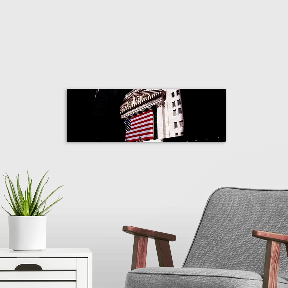 A modern room featuring Low angle view of an American flag on a financial building, New York Stock Exchange, Wall Street,...