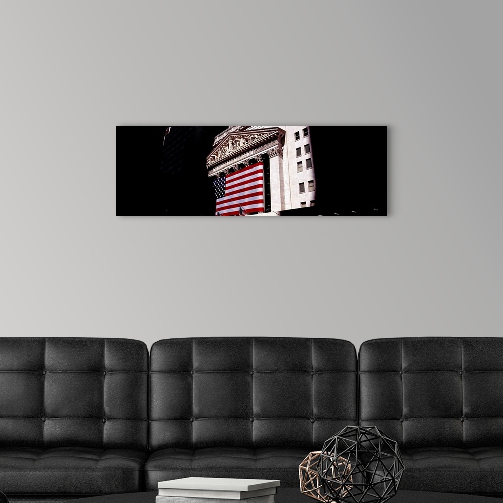 A modern room featuring Low angle view of an American flag on a financial building, New York Stock Exchange, Wall Street,...