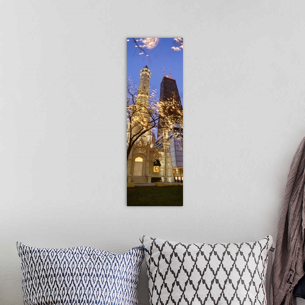 A bohemian room featuring Vertical, low angle photograph on a big canvas, of the Old Water Tower, lit up at night, seen thr...