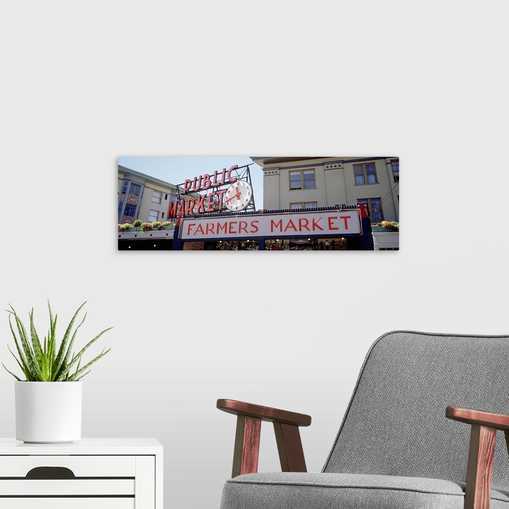 A modern room featuring Long canvas print of the Farmer's Market sign in Seattle with the entrance seen below.