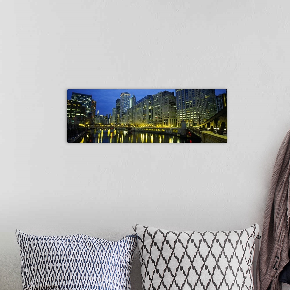 A bohemian room featuring Long canvas of the Chicago River with the city lit up around it.