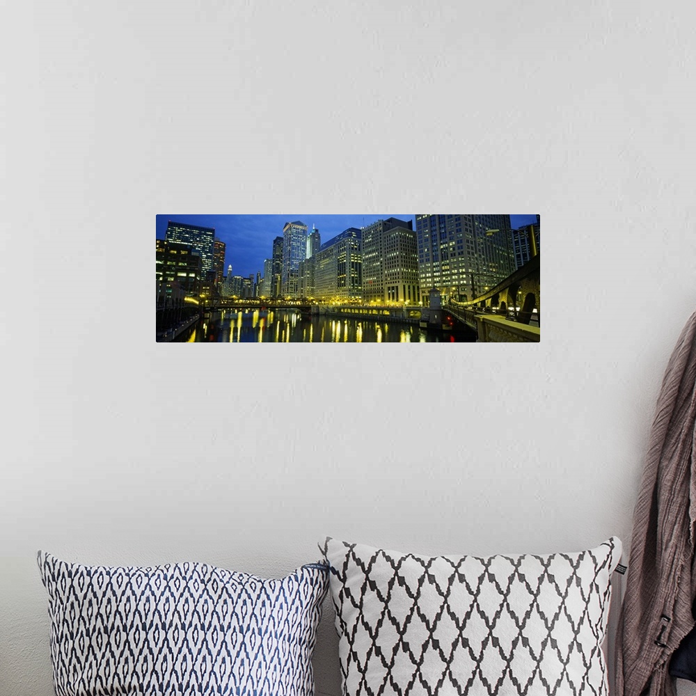 A bohemian room featuring Long canvas of the Chicago River with the city lit up around it.