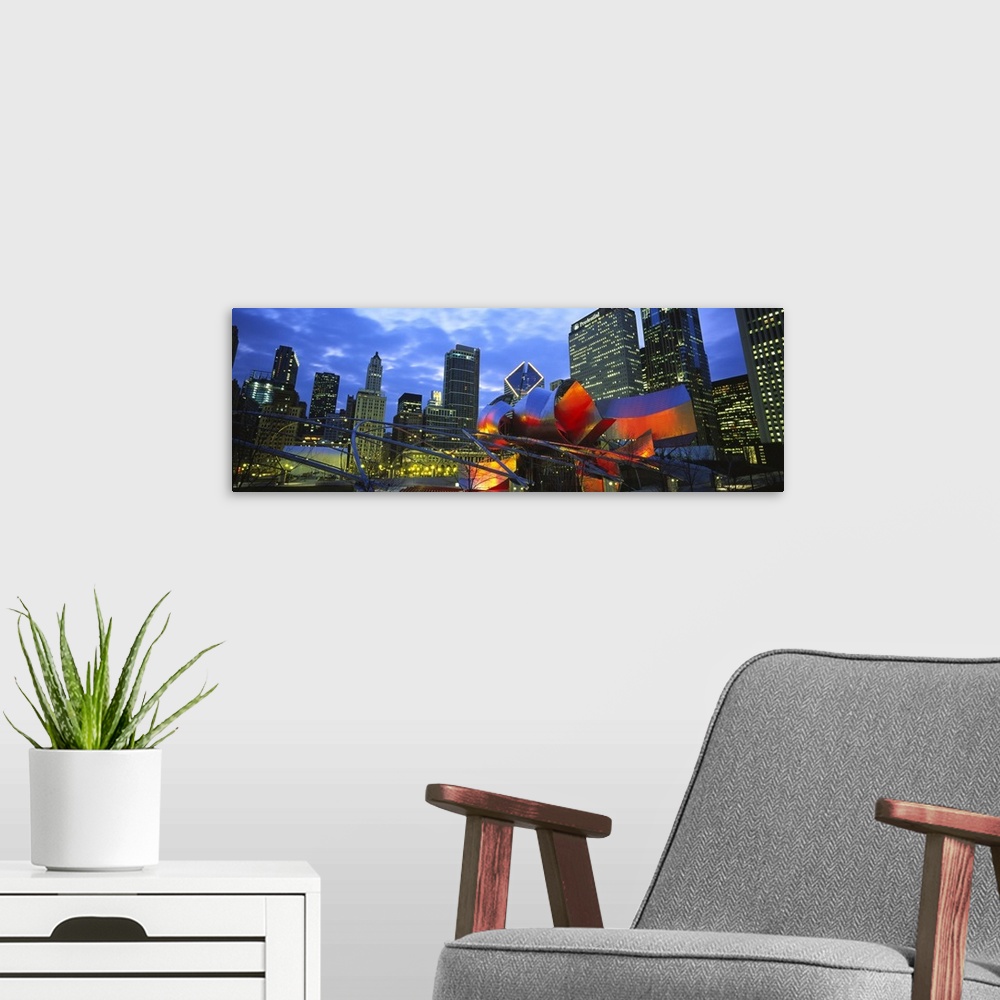 A modern room featuring A panoramic shaped wall hanging shows the interior of a city park looking up at the skylineos sky...