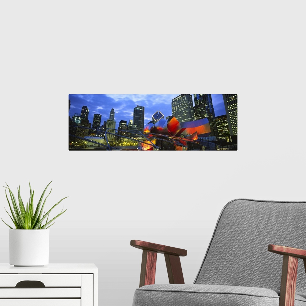 A modern room featuring A panoramic shaped wall hanging shows the interior of a city park looking up at the skylineos sky...