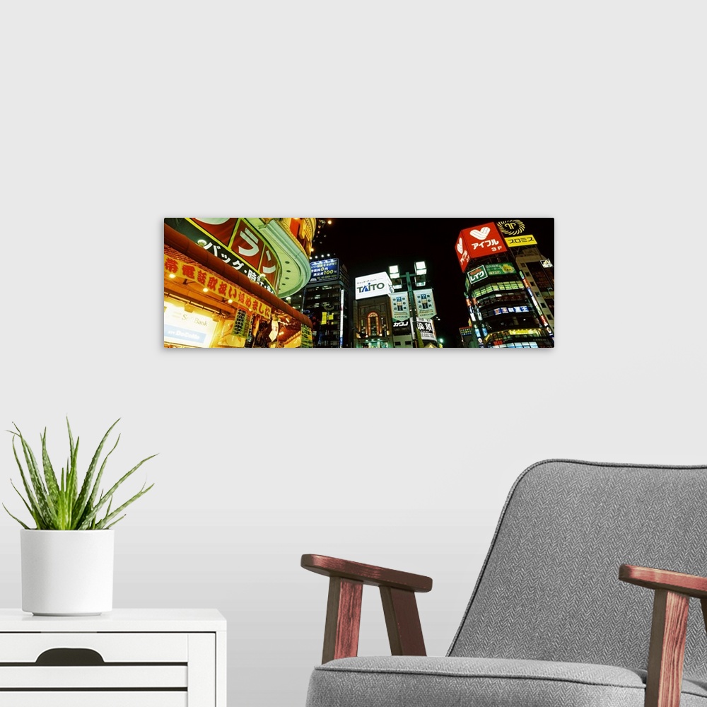 A modern room featuring Low angle view of buildings lit up at night Shinjuku Ward Tokyo Prefecture Kanto Region Japan