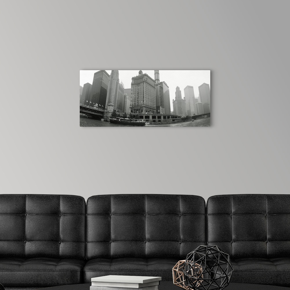 A modern room featuring Large, horizontal photograph of boats and skyscrapers, taken at a low angle from the waterfront o...