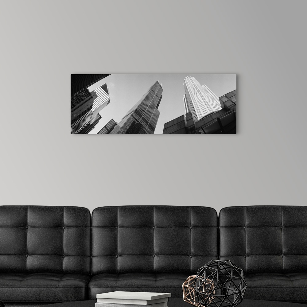 A modern room featuring View from the bottom looking up at big buildings in Chicago on canvas.