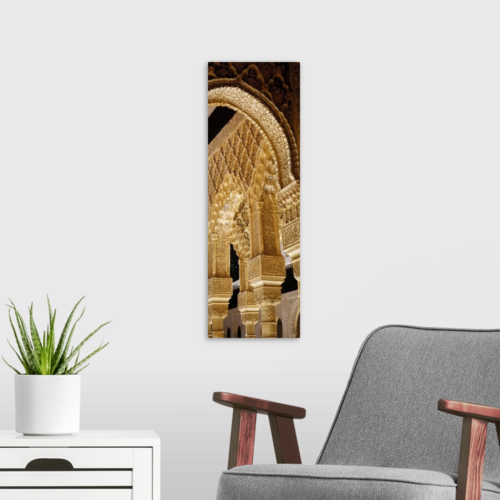 A modern room featuring Low angle view of carving on arches and columns of a palace, Court Of Lions, Alhambra, Granada, A...