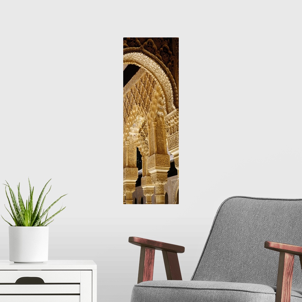 A modern room featuring Low angle view of carving on arches and columns of a palace, Court Of Lions, Alhambra, Granada, A...