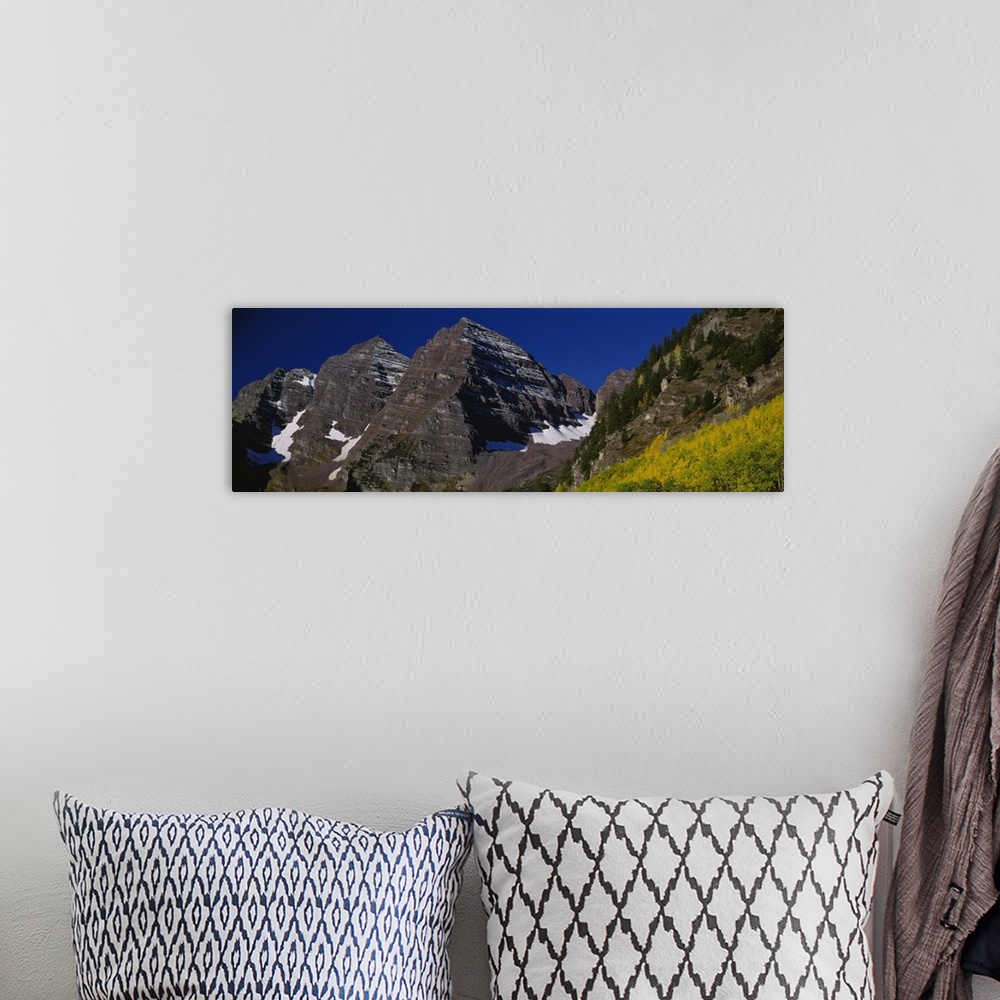 A bohemian room featuring Panoramic photo print of a rugged mountain range up close.