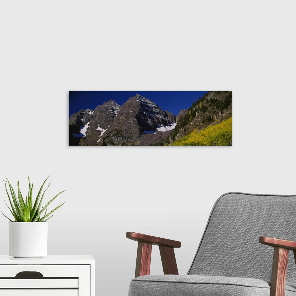 A modern room featuring Panoramic photo print of a rugged mountain range up close.