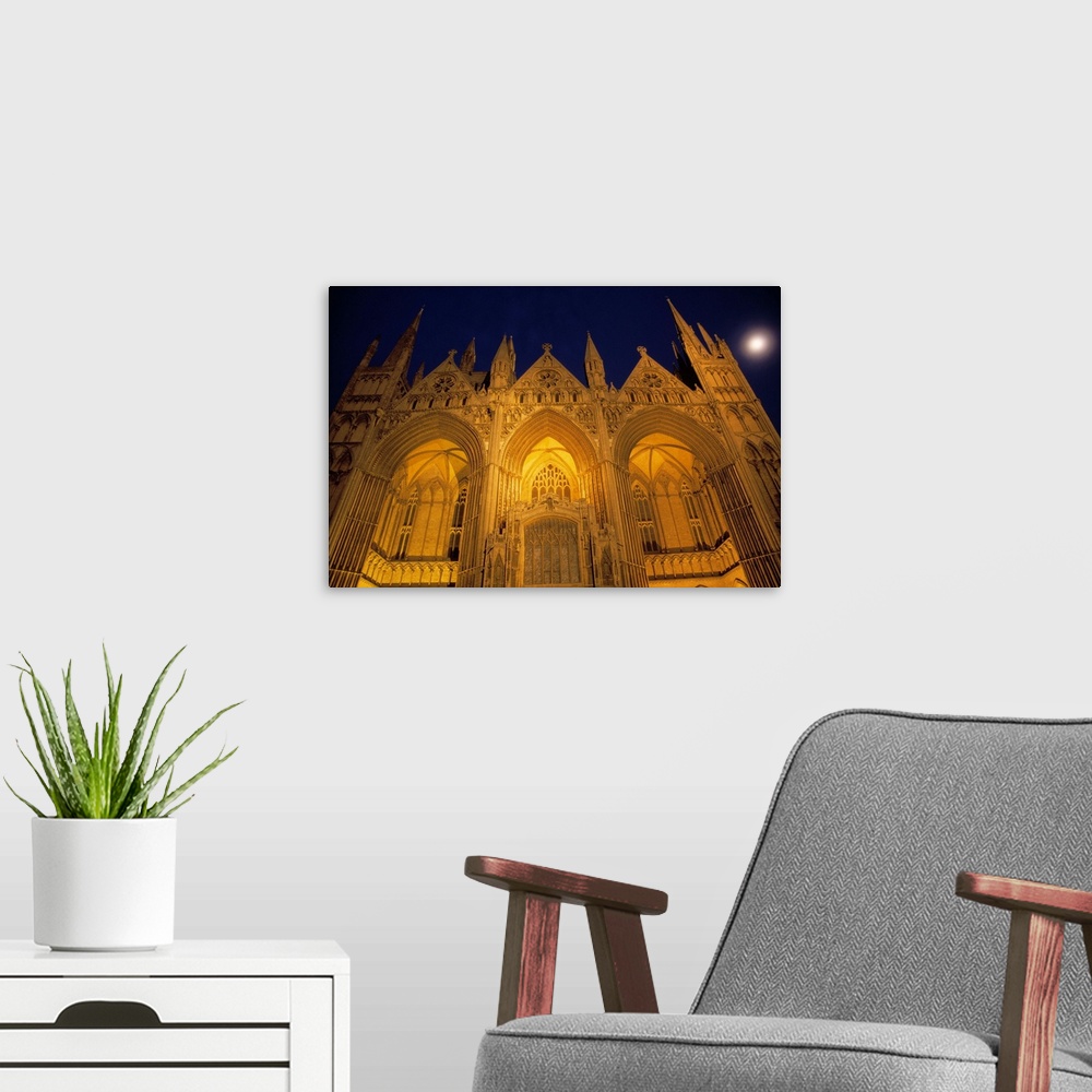 A modern room featuring Low-angle view of Peterborough Cathedral illuminated at night, Peterborough, England.