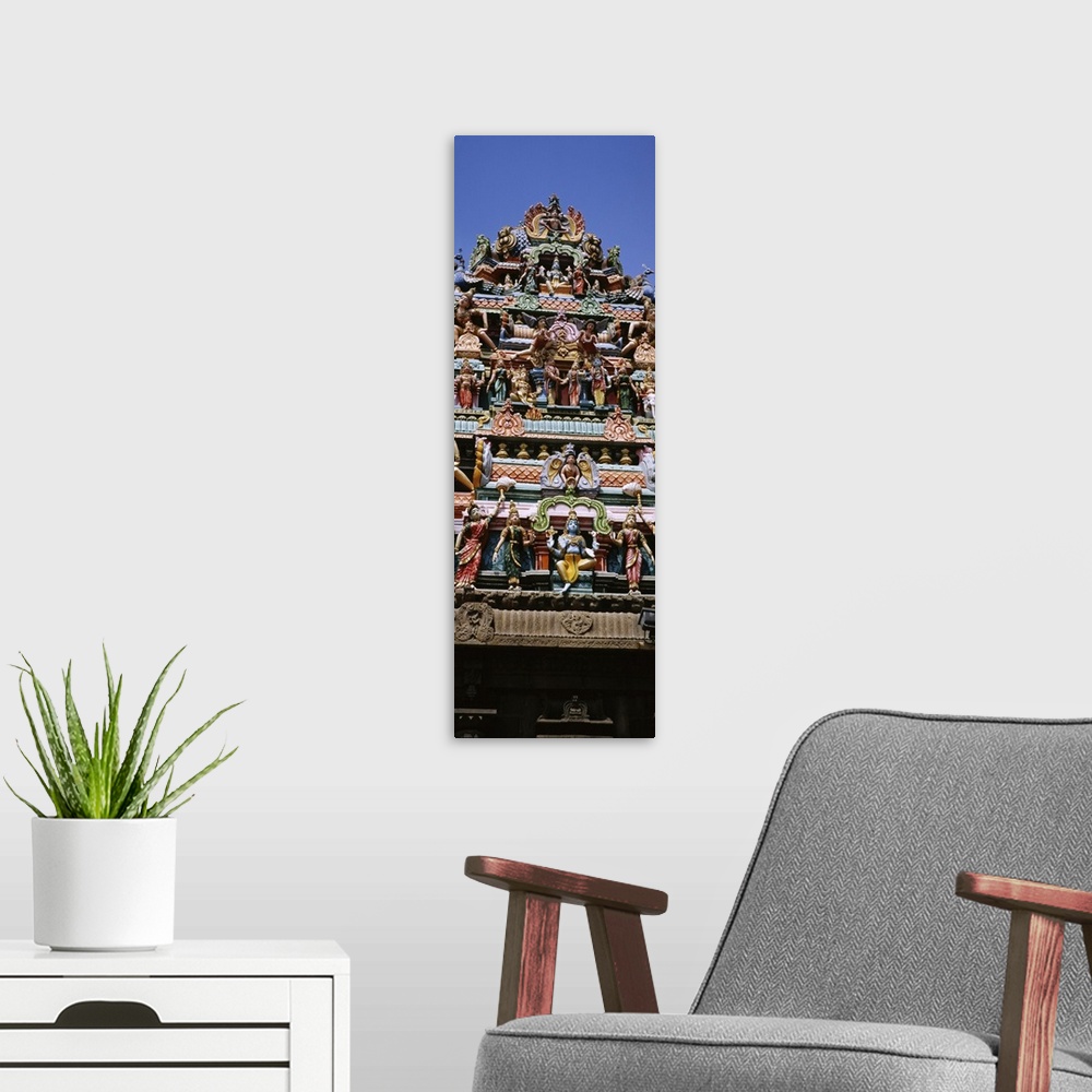 A modern room featuring Low angle view of statues of Hindu gods on the roof of a temple, Arulmigu Kapaleeswarar Temple, C...