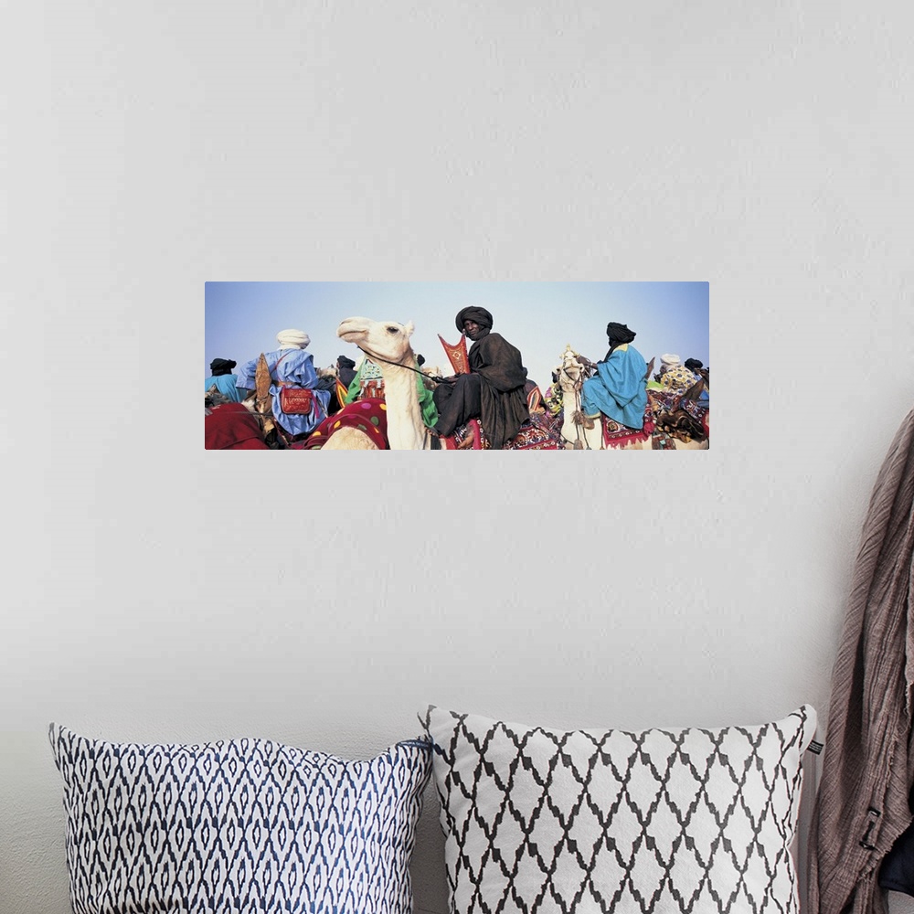 A bohemian room featuring Low angle view of tuaregs riding on camels, Mali
