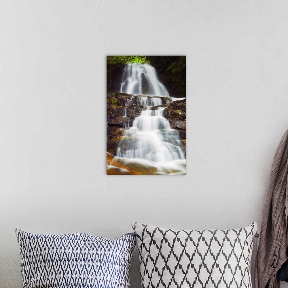 A bohemian room featuring Vertical photograph on a large canvas of Laurel Creek Falls spilling over a rocky hillside in the...