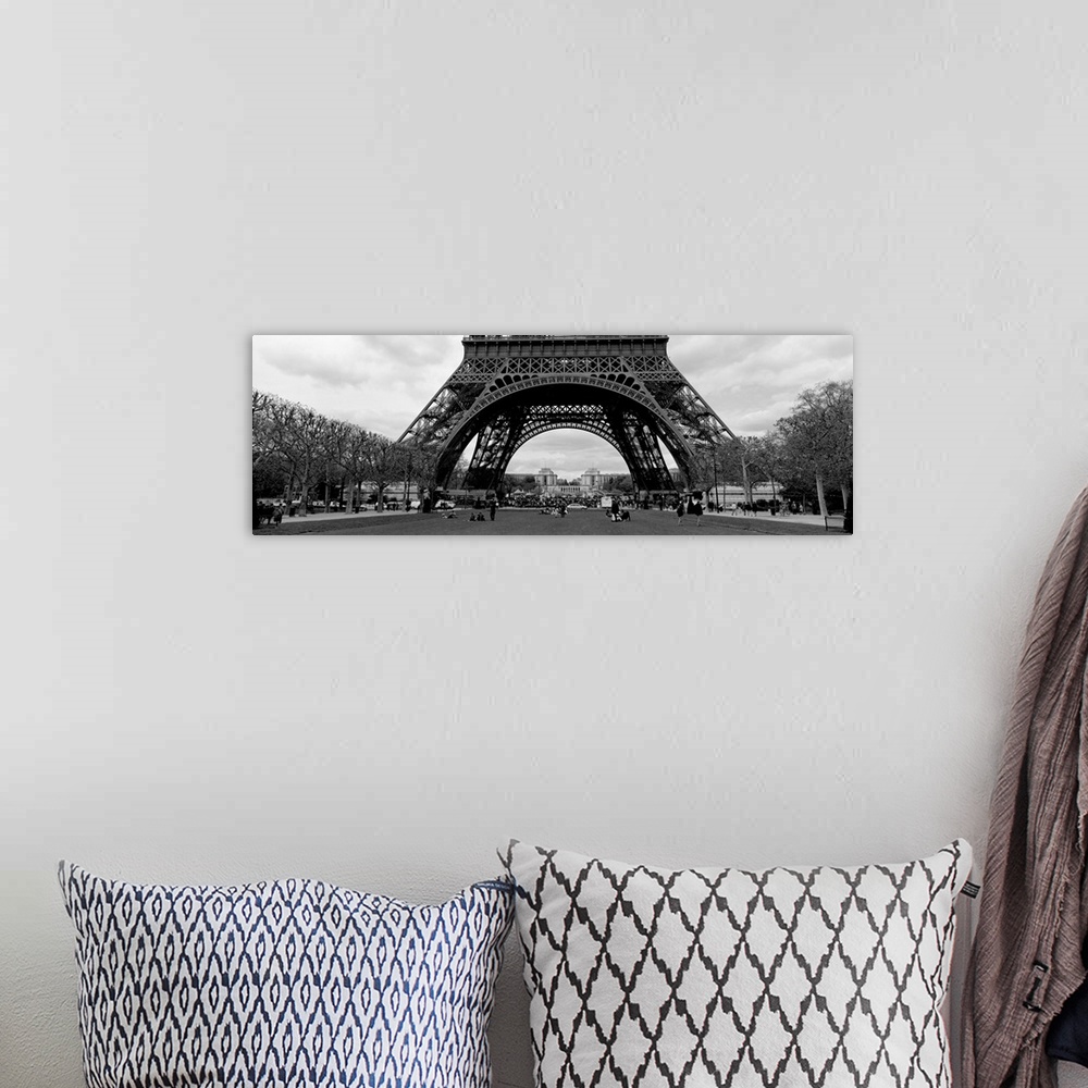 A bohemian room featuring This decorative wall art is a panoramic photograph of the base of the tower and the park that sur...