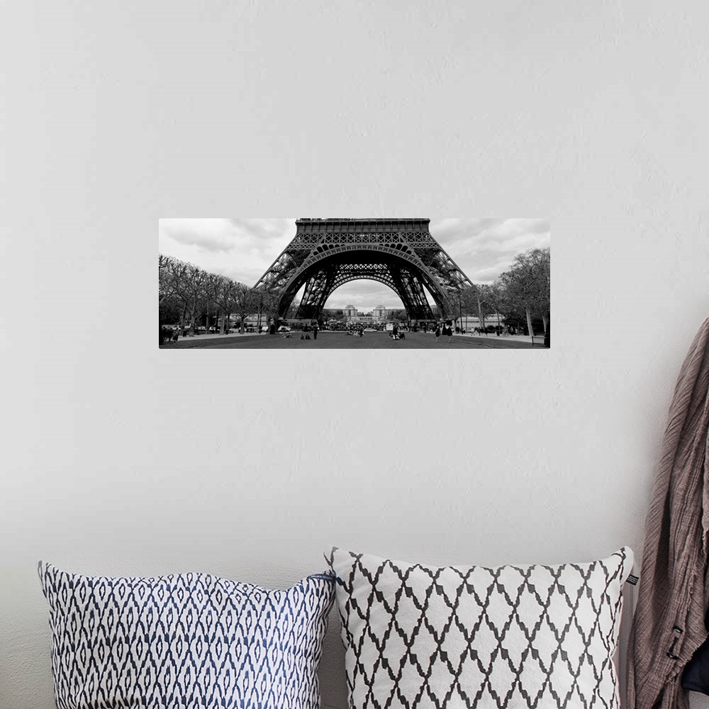A bohemian room featuring This decorative wall art is a panoramic photograph of the base of the tower and the park that sur...