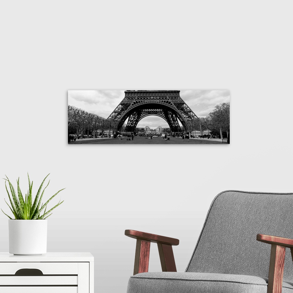 A modern room featuring This decorative wall art is a panoramic photograph of the base of the tower and the park that sur...