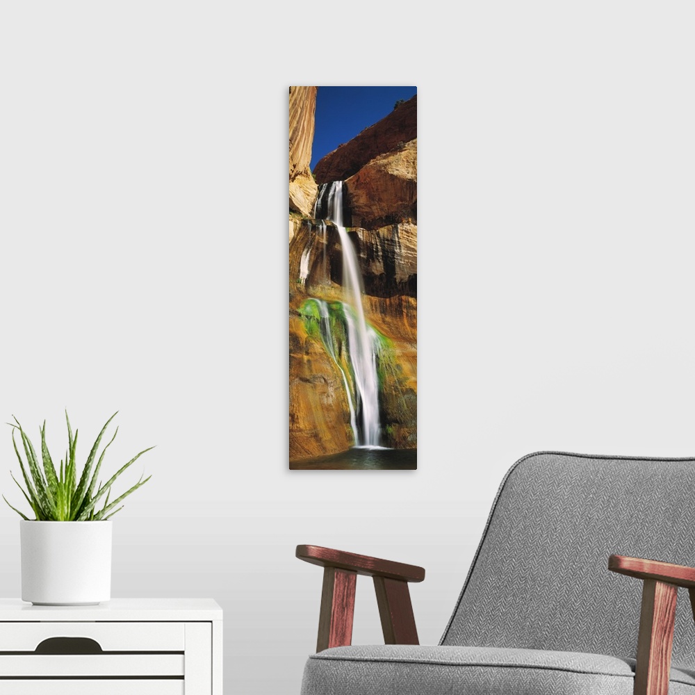 A modern room featuring A vertical photograph taken with the time lapsed technique show the flow of the water down the ro...