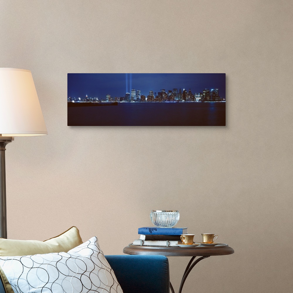 A traditional room featuring Panoramic photograph of lit up skyline and waterfront at night.