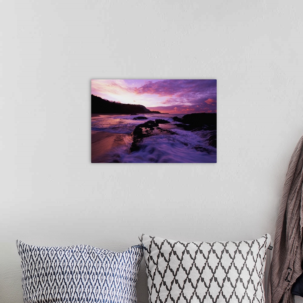 A bohemian room featuring Photograph of rocky shoreline with waves rolling in at dusk.  There is a silhouette of a forest i...