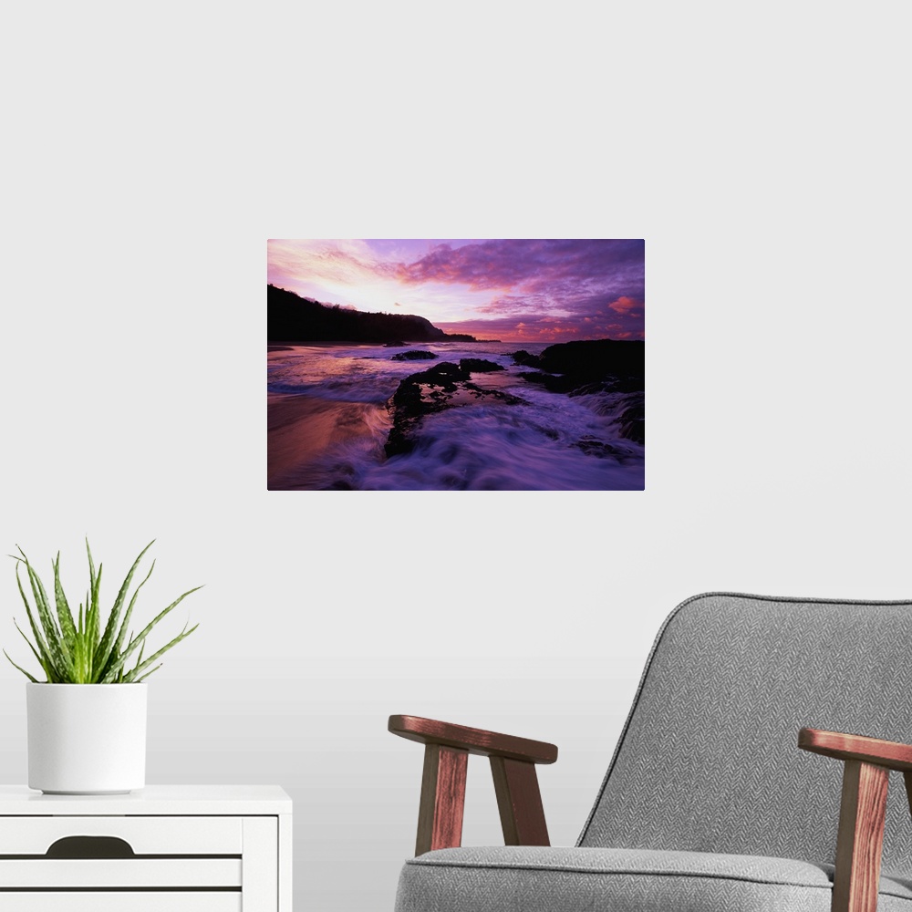 A modern room featuring Photograph of rocky shoreline with waves rolling in at dusk.  There is a silhouette of a forest i...