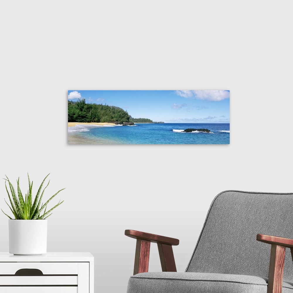 A modern room featuring Large panoramic photo of Lumahai Beach in Kauai, Hawaii during the summer.