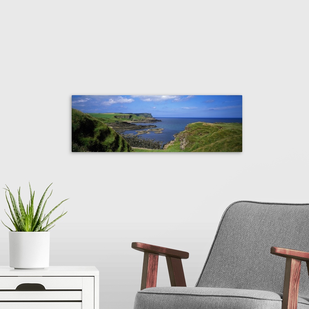 A modern room featuring Lush green coastal cliffs, blue sea, Northern Ireland