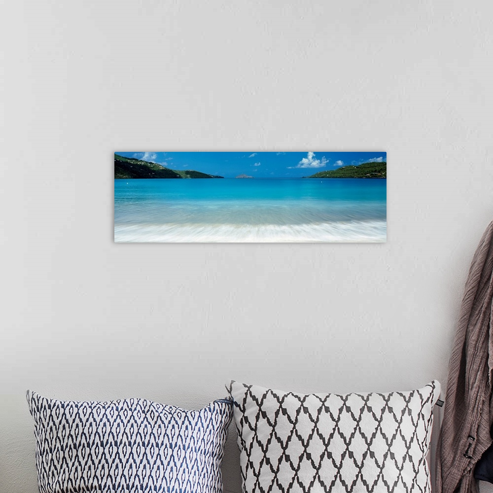 A bohemian room featuring Panoramic photograph of clear water in a calm sea washing up a tropical beach.