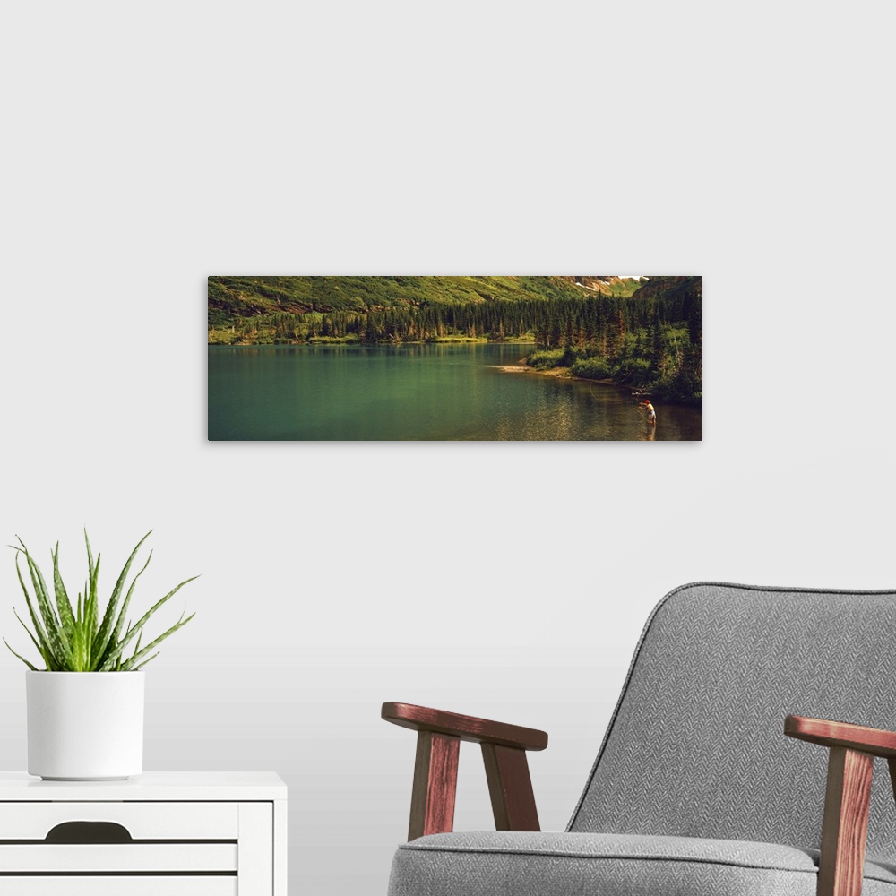 A modern room featuring Man fly fishing on the Bullhead Lake, US Glacier National Park, Montana